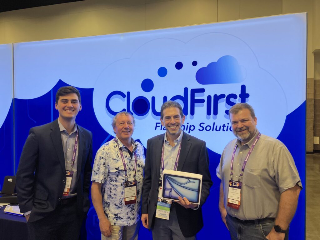 Figure 3. L to R: Alec Lewis, Hal Schwartz, POWERUp Attendee and Chuck Paolillo at the CloudFirst booth at COMMON POWERUp 2024